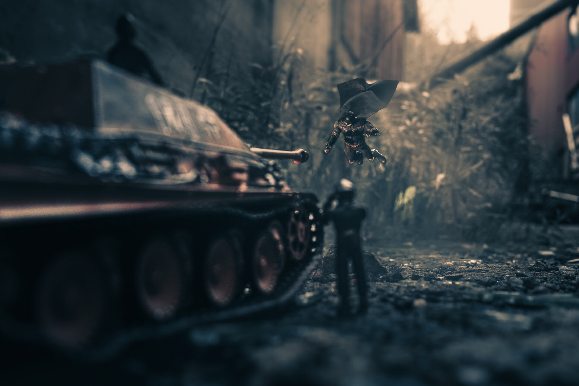 Miniatyrfoto av leketøysfigur av Batman som svever mot en leketøystank